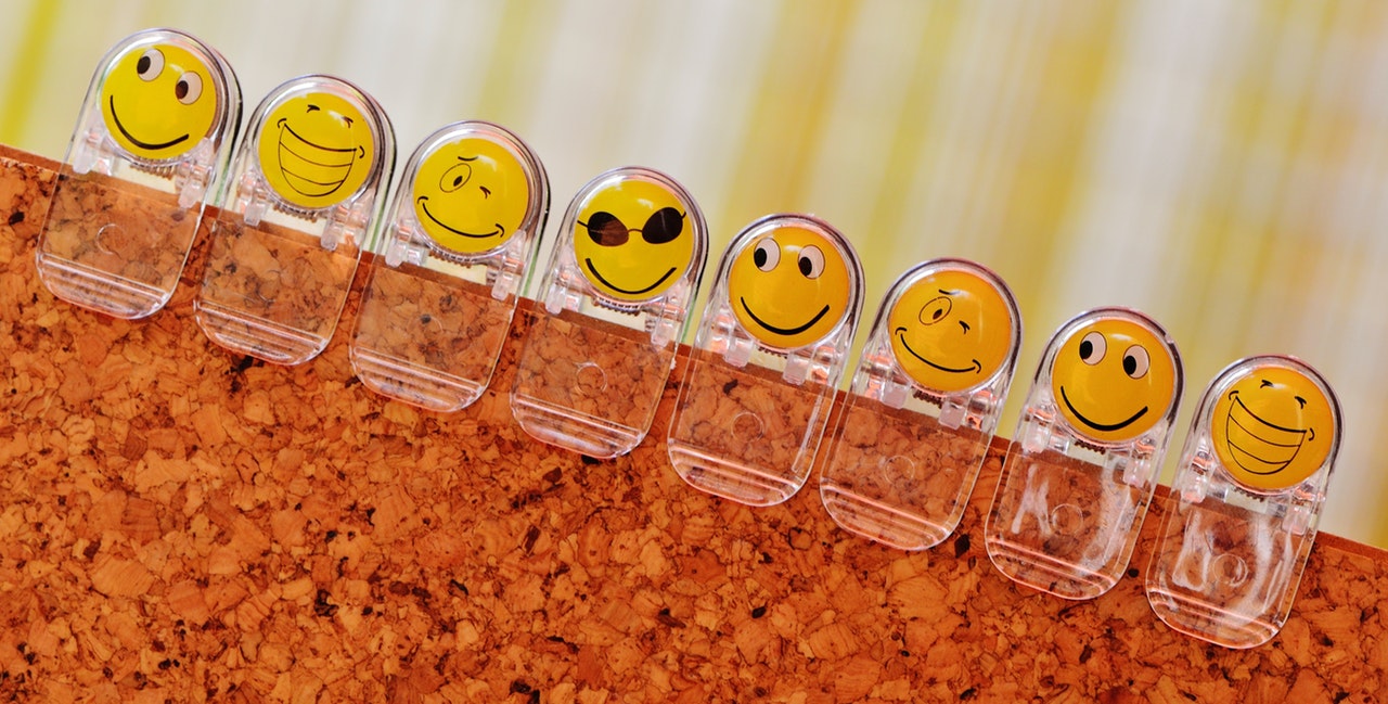 A row of novelty paperclips featuring different yellow faces with various expressions A row of novelty paperclips featuring different yellow faces with various expressions