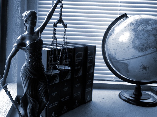 Lady Justice legal books and a globe 