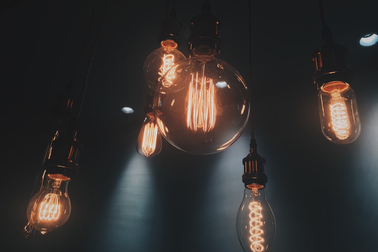 Six lit up light bulbs in an assortment of designs and shapes. Six lit up light bulbs in an assortment of designs and shapes.