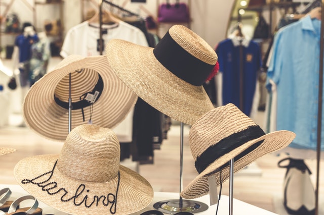 4 brown straw hats on display 