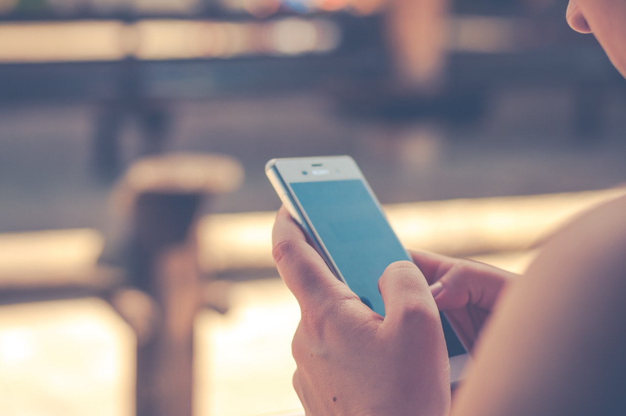 Woman holding mobile phone Woman holding mobile phone