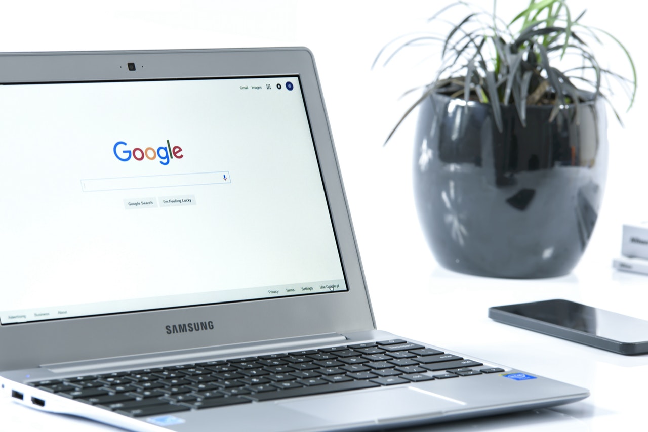 Laptop on a table opened to Google Laptop on a table opened to Google