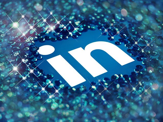 The LinkedIn logo presented in the middle of the image surrounded by sparkling sequins 