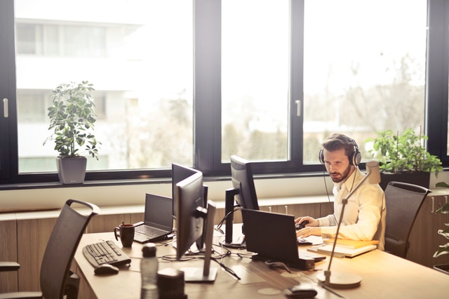 Person working at his desk wearing headphones