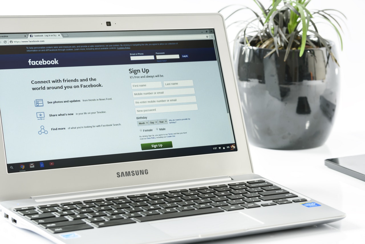 A laptop opened to the Facebook login pa A laptop opened to the Facebook login pa