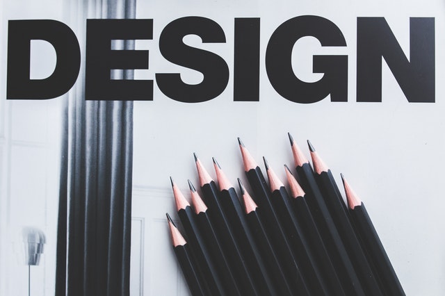 Black pencils and the word 'design'