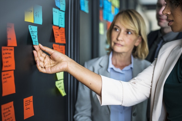 Woman touching blue sticky note Woman touching blue sticky note