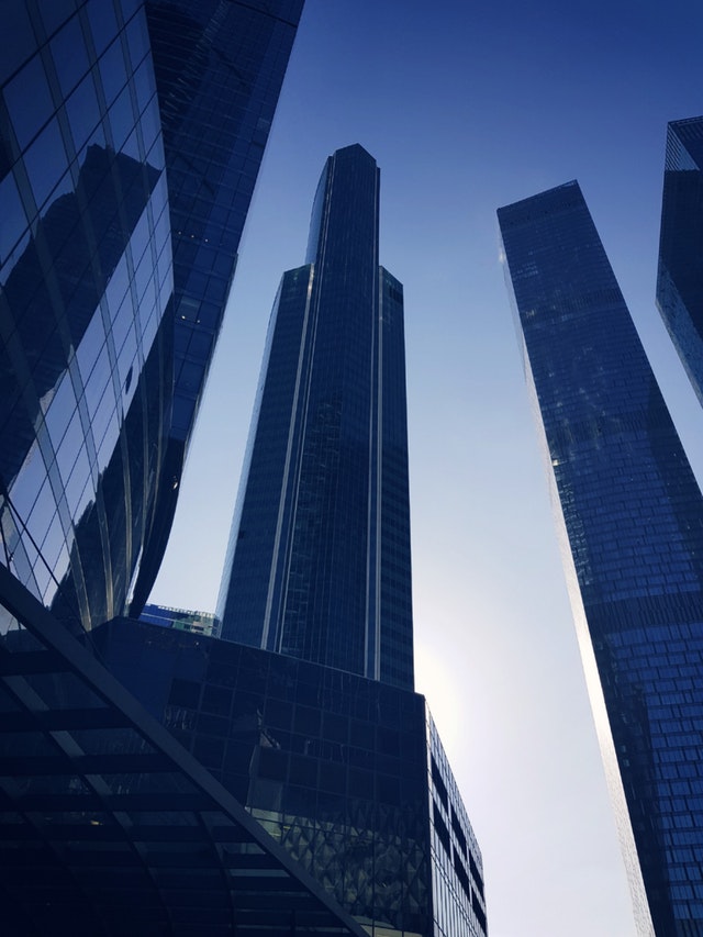 Blue glass panelled buildings against a clear evening sky Blue glass panelled buildings against a clear evening sky