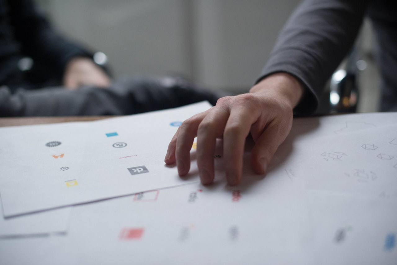 Close up of a hand placed upon paperwork