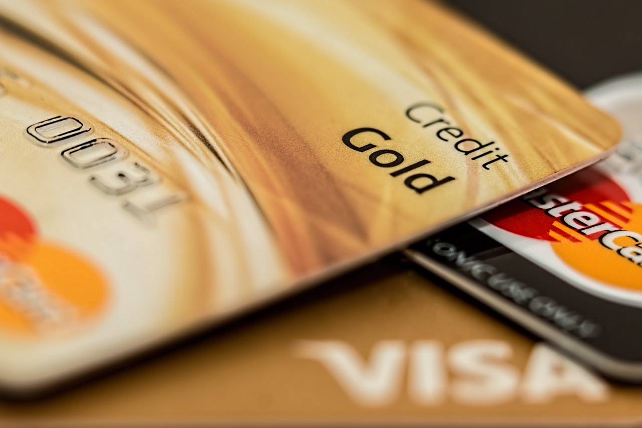 Close up of two Visa credit card Gold cards and a MasterCard Close up of two Visa credit card Gold cards and a MasterCard