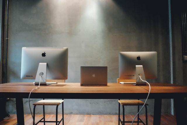 2 iMacs on a table