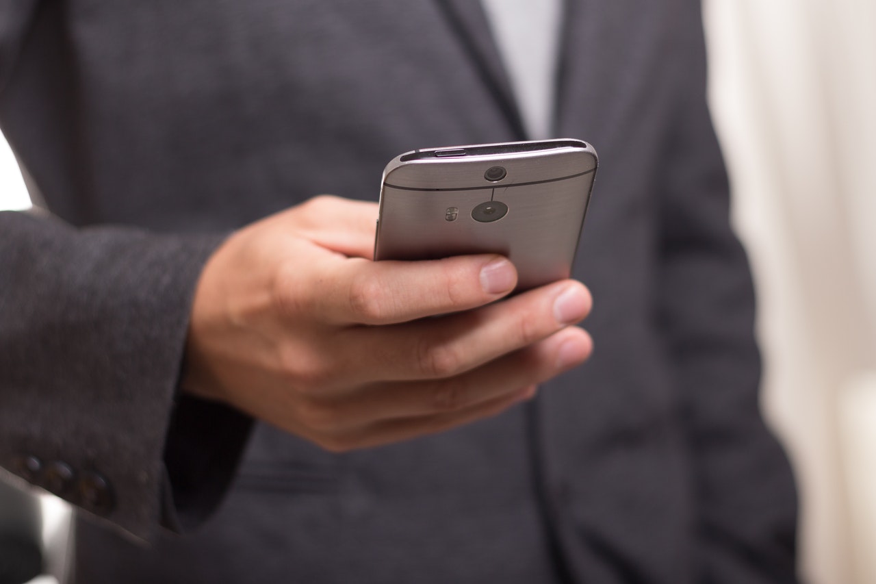Man holding a mobile phone Man holding a mobile phone