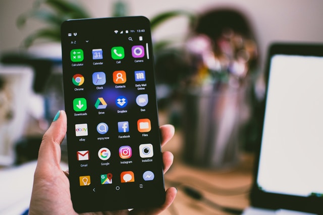 Person holding smartphone Person holding smartphone