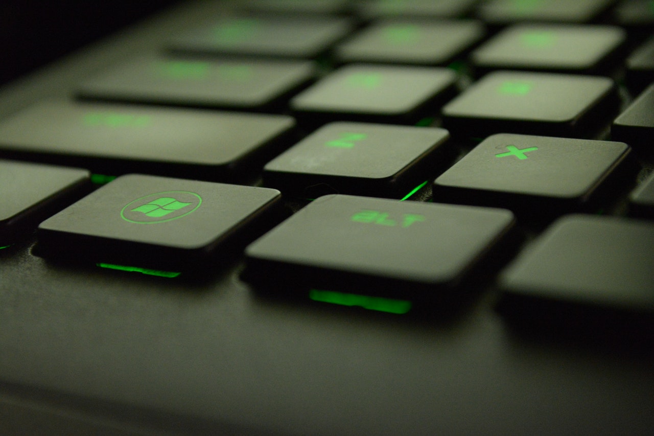 Close up of a laptop keyword with black keys and green letters