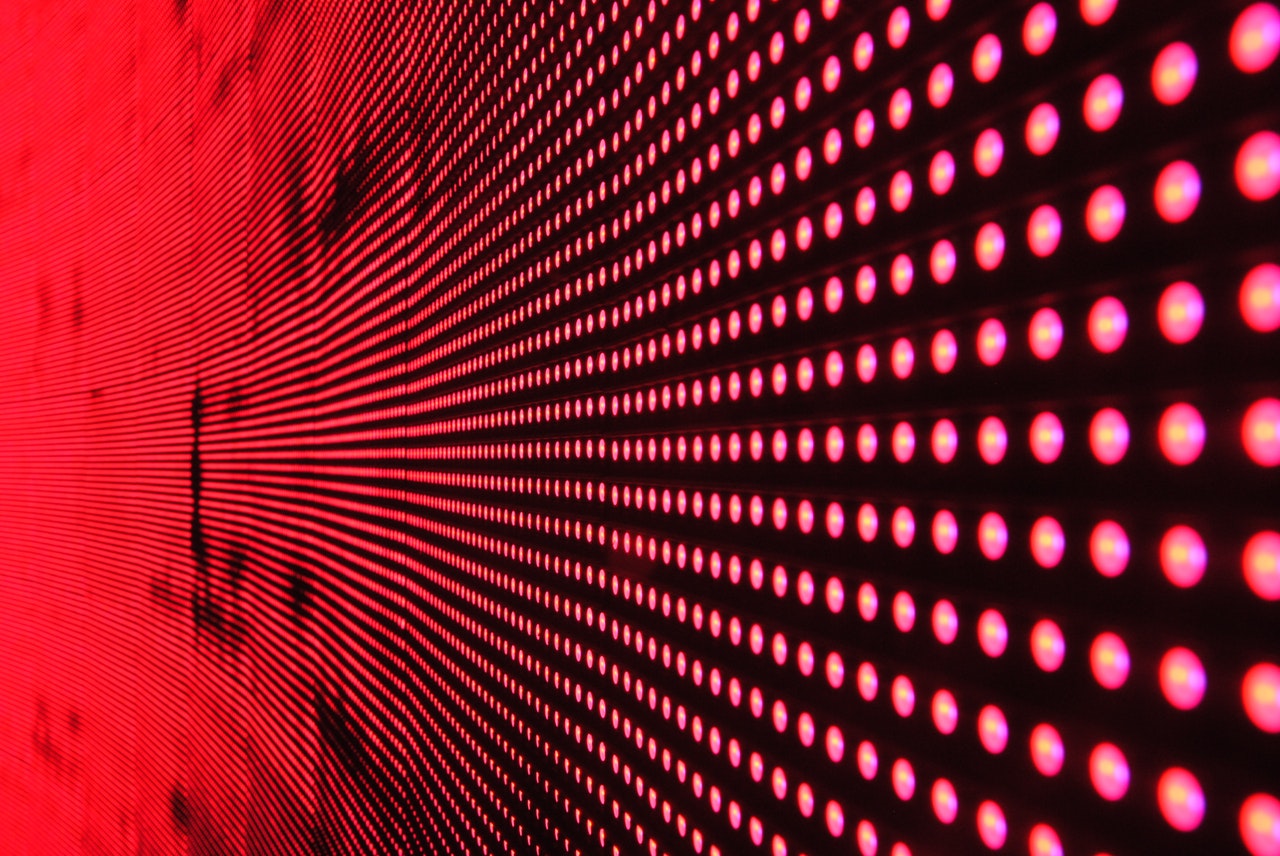 Red lights in line on black surface 